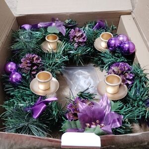 Decorative Green Holiday Wreath with Purple Accents and Gold Candle Holders